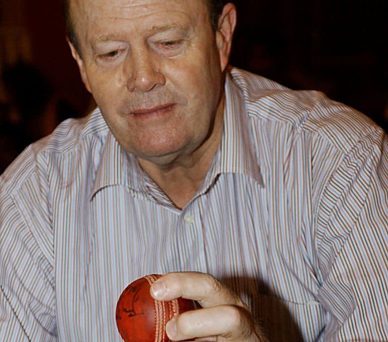 Former England cricket captain Tony Greig looks at a cricket ball used by spinner Harbhajan Singh when he became the first Indian to take Test hat-trick, at an auction of cricket memorabilia in Bangalore, on September 12, 2003. Flamboyant ex-England skipper and television commentator died of a heart attack on Saturday at the age of 66 as he battled lung cancer