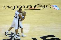 Jun 15, 2014; San Antonio, TX, USA; San Antonio Spurs forward Boris Diaw (33) celebrates with guard Tony parker (9) during a called timeout from the game against the Miami Heat in game five of the 2014 NBA Finals at AT&T Center. Brendan Maloney-USA TODAY Sports