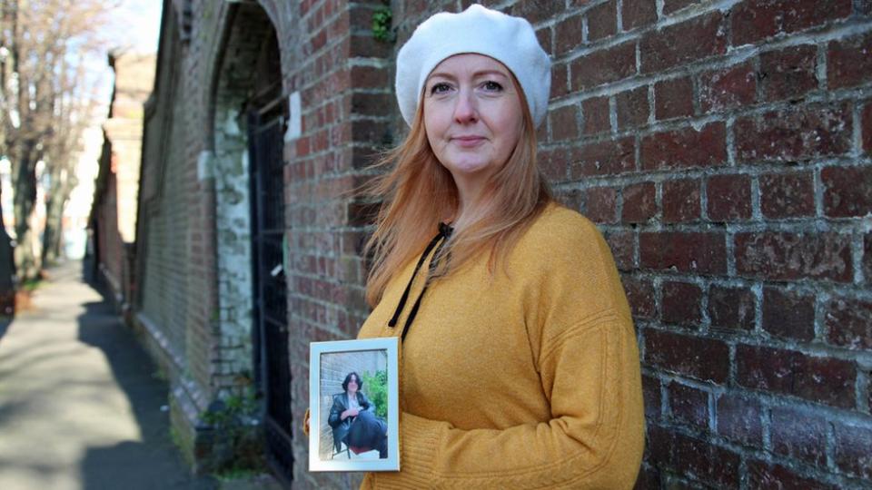 Claire Rocha holding a picture of her son Dylan