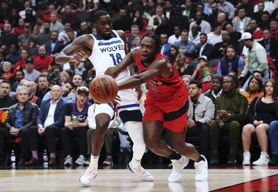 Minnesota Timberwolves' Shake Milton (18) trips Toronto Raptors' O.G. Anunoby (3) during the first half of an NBA basketball game Wednesday, Oct. 25, 2023, in Toronto. (Nathan Denette/The Canadian Press via AP)