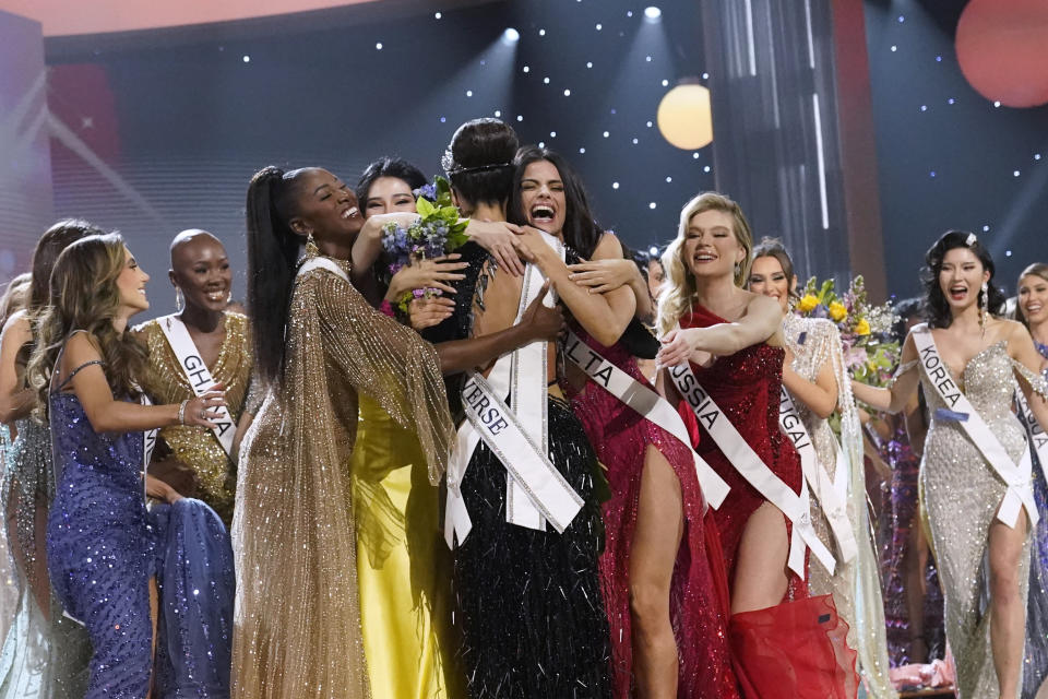 Miss USA R'Bonney Gabriel, back to camera, is hugged by other contestants after being crowned Miss Universe at the 71st Miss Universe pageant, in New Orleans on Saturday, Jan. 14, 2023. (AP Photo/Gerald Herbert)