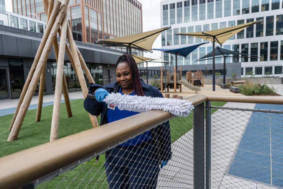 Jessica Gregory, a custodian with the state Department of General Services, cleans a railing in the childcare center area of the May Lee State Office Complex during its grand opening Wednesday, April 24, 2024.