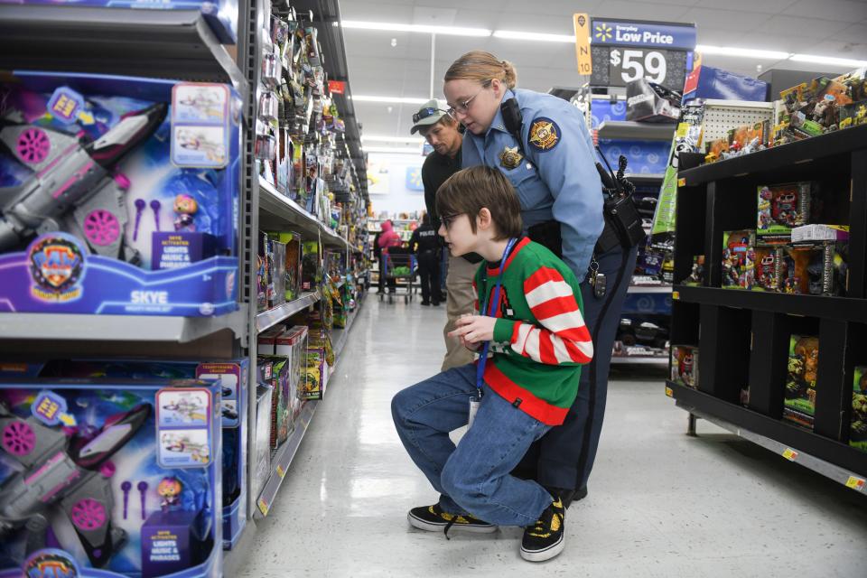 Landon Kamp bends down to look at toys during the Columbia County Sheriff's Office Day with a Deputy at Walmart on Thursday, Dec. 21, 2023.