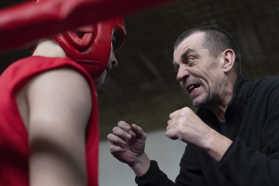 Coach Bohdan Dmytrenko speaks to a young boxer during a boxing tournament in honor of Maksym Halinichev, who was killed during fighting with Russian forces in March 2023, in Romny, Sumy region, Ukraine on Sunday, Feb. 4, 2024. (AP Photo/Evgeniy Maloletka)