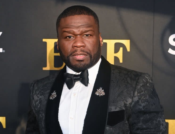 50 Cent in a suit and bowtie on the red carpet