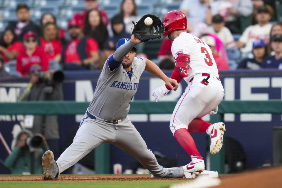 Los Angeles Angels' Taylor Ward (3) is safe at first ahead of a throw to Kansas City Royals first baseman Vinnie Pasquantino during the first inning of a baseball game in Anaheim, Calif., Friday, May 10, 2024. (AP Photo/Ashley Landis)