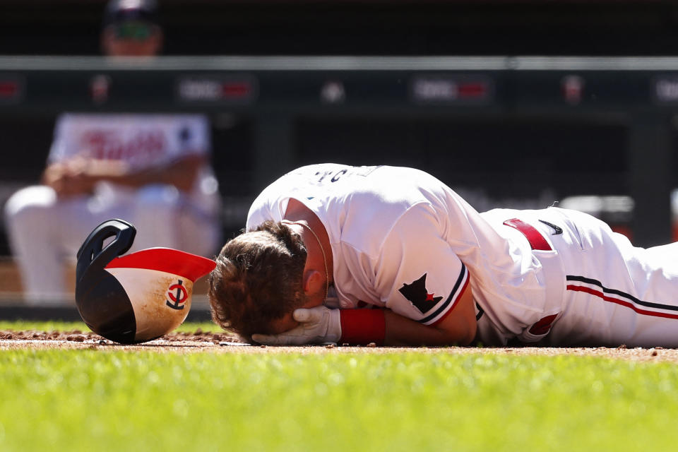 April 12, 2023;  Minneapolis, Minnesota, USA;  Minnesota Twins second baseman Kyle Farmer falls to the ground after being hit in the face by the Chicago White Sox in the fourth inning at Target Field.  Mandatory credit: Bruce Kluckhohn-USA TODAY Sports