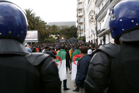 Police officers stand guard during a protest against the appointment of interim president, Abdelkader Bensalah and demanding radical changes to the political system, in Algiers, Algeria April 10, 2019. REUTERS/Ramzi Boudina