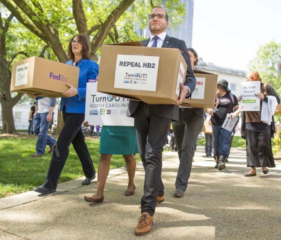 Chad Griffin and supporters carry boxes of petitions