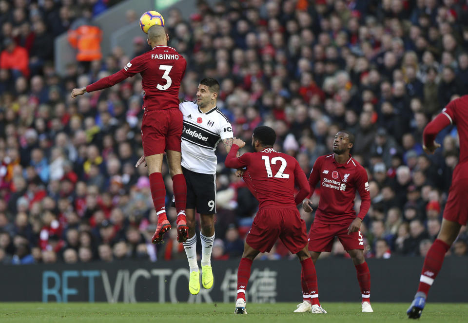 Liverpool's Fabinho, left, wins a header against Fulham's Aleksandar Mitrovic, during the English Premier League soccer match between Liverpool and Fulham, at Anfield Stadium, in Liverpool, England, Sunday, Nov. 11, 2018. (Barrington Coombs/PA via AP)