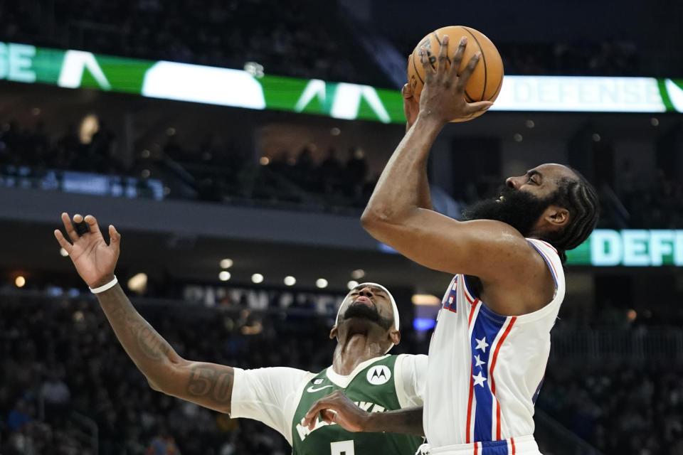 Philadelphia 76ers' James Harden, right, is fouled as he drives to the basket against Milwaukee Bucks' Bobby Portis during the first half of an NBA basketball game Saturday, March 4, 2023, in Milwaukee. (AP Photo/Aaron Gash)