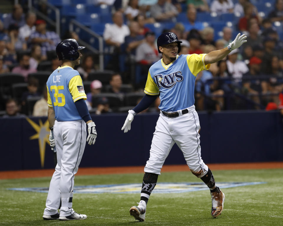 Tampa Bay Rays' Willy Adames, right, celebrates with teammate Brandon Lowe after scoring during the third inning of a baseball game against the Boston Red Sox, Friday, Aug. 24, 2018, in St. Petersburg, Fla. (AP Photo/Scott Audette)