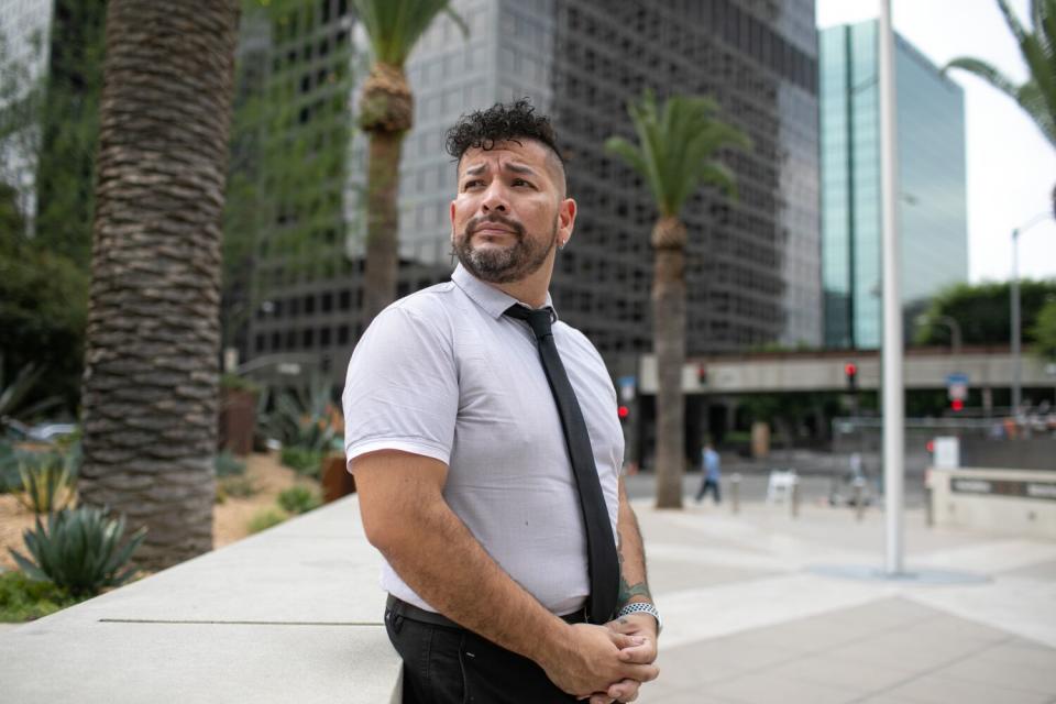 A man stands outside a building