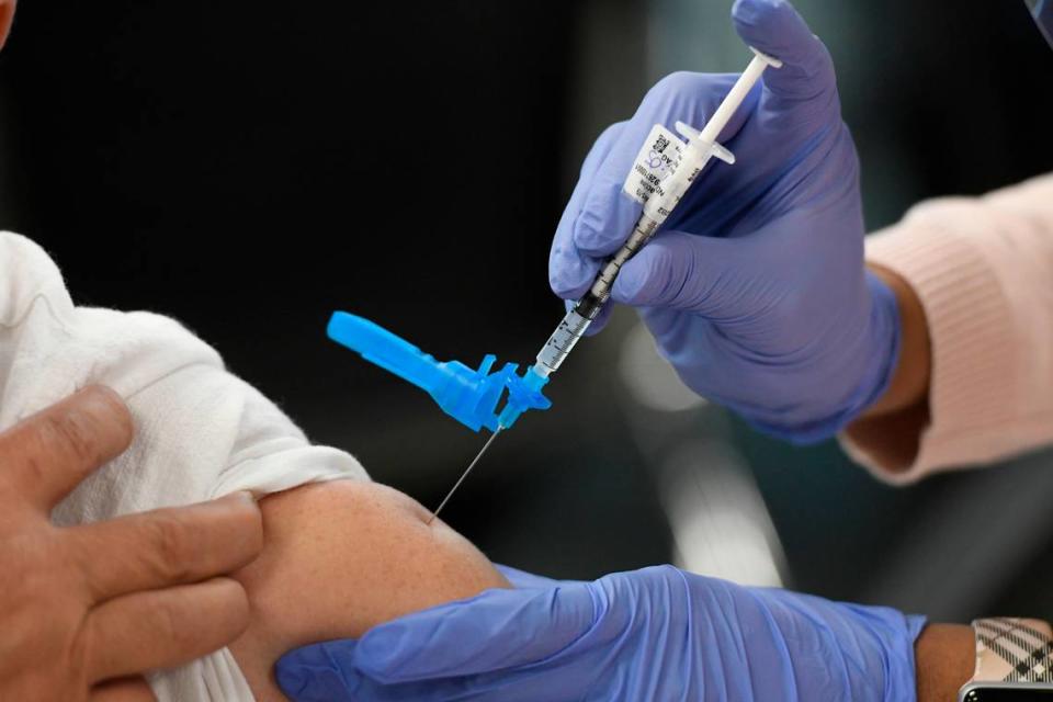 A patient receives a dose of the Pfizer COVID vaccine at a pop-up clinic in Garner, N.C., Saturday, March 13, 2021.