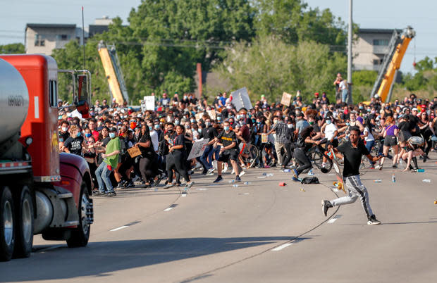 Tanker truck drives into protesters on bridge 