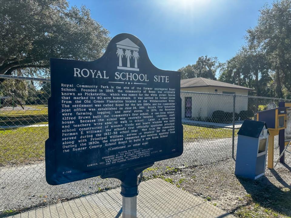 A historical marker for the Royal School, the site where the former segregated school was, sits in front of the Alonzo A. Young Sr. Enrichment & Historical Center where Beverly Steele hosts her youth programming. (Aallyah Wright/Capital B)