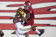 Rutgers' Christian Izien defends against Michigan's Cornelius Johnson during the third overtime of an NCAA college football game Saturday, Nov. 21, 2020, in Piscataway, N.J. Michigan won 48-42. (AP Photo/Frank Franklin II)