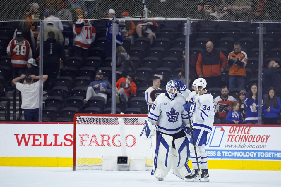 Toronto Maple Leafs' Ilya Samsonov (35) and Auston Matthews (34) celebrate after the Maple Leafs won an NHL hockey game against the Philadelphia Flyers, Thursday, March 14, 2024, in Philadelphia. (AP Photo/Matt Slocum)