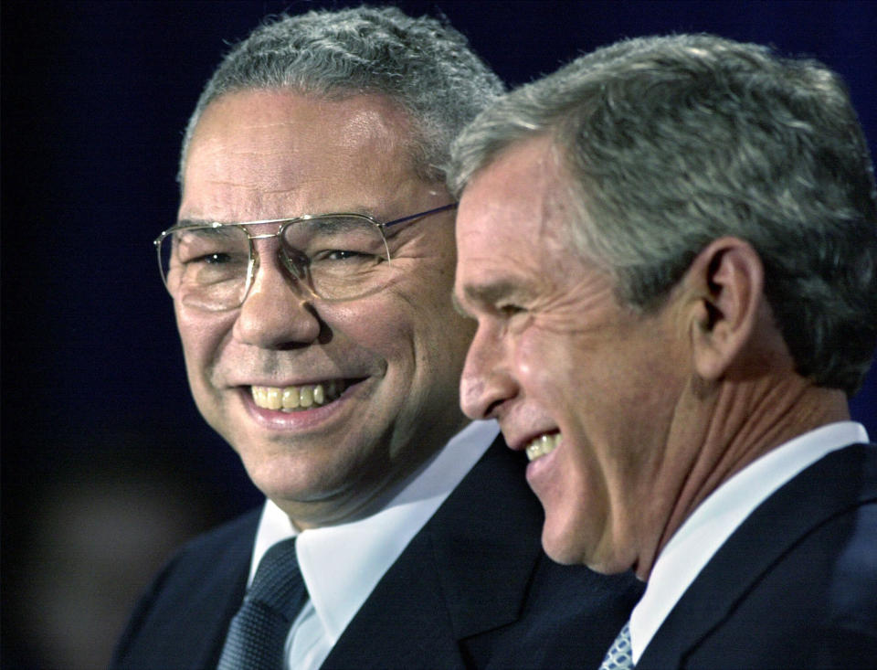 President-elect Bush smiles as he introduces retired Gen. Colin Powell, left, as his nominee to be secretary of state during a ceremony in Crawford, Texas, Saturday, Dec. 16, 2000. Powell served as chairman of the Joint Chiefs of Staff under President George Bush, father of the president-elect.  (David J. Phillip/AP)