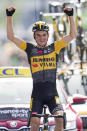 Sepp Kuss of the US celebrates as he crosses the finish line to win the fifteenth stage of the Tour de France cycling race over 191.3 kilometers (118.9 miles) with start in Ceret, France, and finish in Andorra-la-Vella, Andorra, Sunday, July 11, 2021. (AP Photo/Christophe Ena)