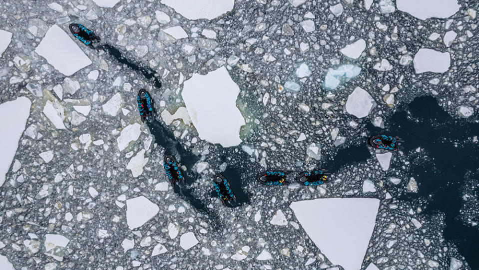 An aerial view of Minerva’s Zodiacs moving through floating, frozen chunks known as brash ice, in the French Passage, where travelers can observe crabeater seals, gentoo penguins and humpback whales. - Credit: Supplied