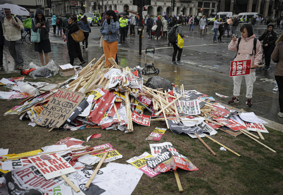 Placards showing anti-Trump messages lie on the ground, in central London, near the end of a protest against the state visit of President Donald Trump, Tuesday, June 4, 2019. Trump will turn from pageantry to policy Tuesday as he joins British Prime Minister Theresa May for a day of talks likely to highlight fresh uncertainty in the allies' storied relationship. (AP Photo/Matt Dunham)