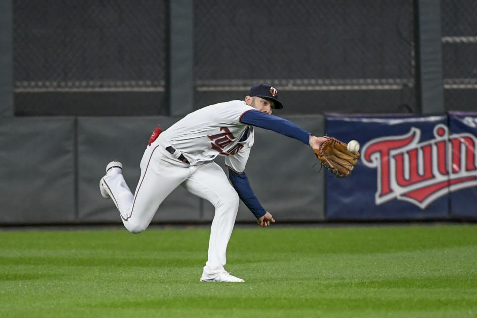 Minnesota Twins' Jake Cave catches a sacrifice fly hit by Chicago White Sox's Josh Harrison during the second inning of a baseball game Wednesday, Sept. 28, 2022, in Minneapolis. (AP Photo/Craig Lassig)