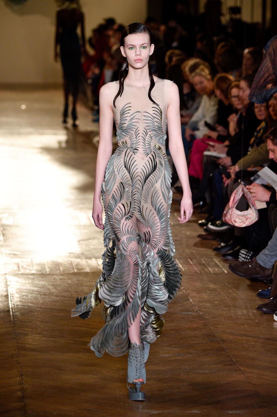 <p>Model wears a semi-sheer dress with silver and gold embellishments from the Iris Van Herpen SS18 Haute Couture show. (Photo: Getty Images) </p>