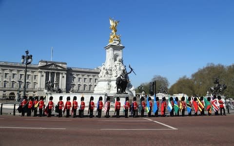 Soldiers of the Coldstream Guards carry flags of the 53 Commonwealth countries at Buckingham Palace  - Credit: Gareth Fuller /PA