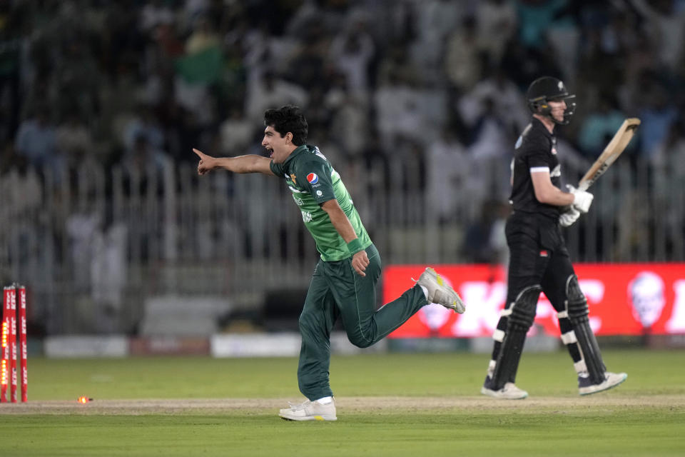 Pakistan's Naseem Shah, center, celebrates after taking the wicket of New Zealand's Adam Milne, right, during the first one-day international cricket match between Pakistan and New Zealand, in Rawalpindi, Pakistan, Thursday, April 27, 2023. (AP Photo/Anjum Naveed)