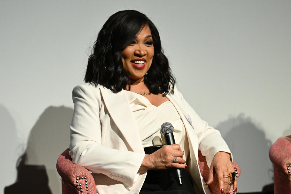 Kim Whitley holding microphone. 