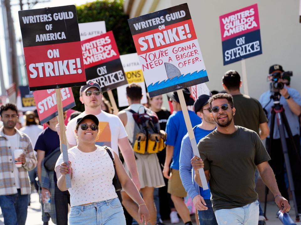 WGA protesters with a sign that reads "You're gonna need a bigger offer."