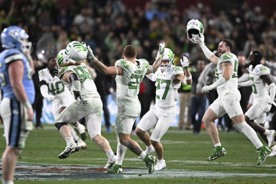 Oregon players celebrate after defeating North Carolina 28-27 in the Holiday Bowl NCAA college football game Wednesday, Dec. 28, 2022, in San Diego. (AP Photo/Denis Poroy)