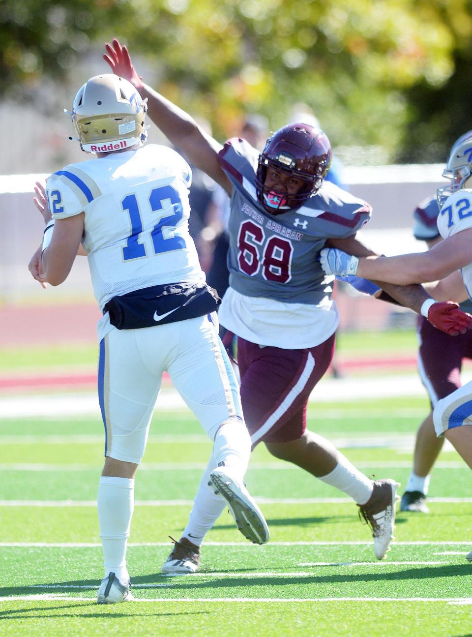 Bethel sophomore Bryan Parker rushes Tabor quarterback Gustavo Villarreal during play Saturday at Bethel.