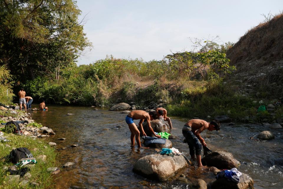 Central American migrants traveling in a caravan headed to the U.S. border wash clothes and take baths in a river on a rest day near Mapastepec in Chiapas state, Mexico, Sunday, April 21, 2019. The outpouring of aid that once greeted Central American migrants as they trekked in caravans through southern Mexico has been drying up, so this group is hungrier, advancing slowly or not at all, and hounded by unhelpful local officials. (AP Photo/Moises Castillo)