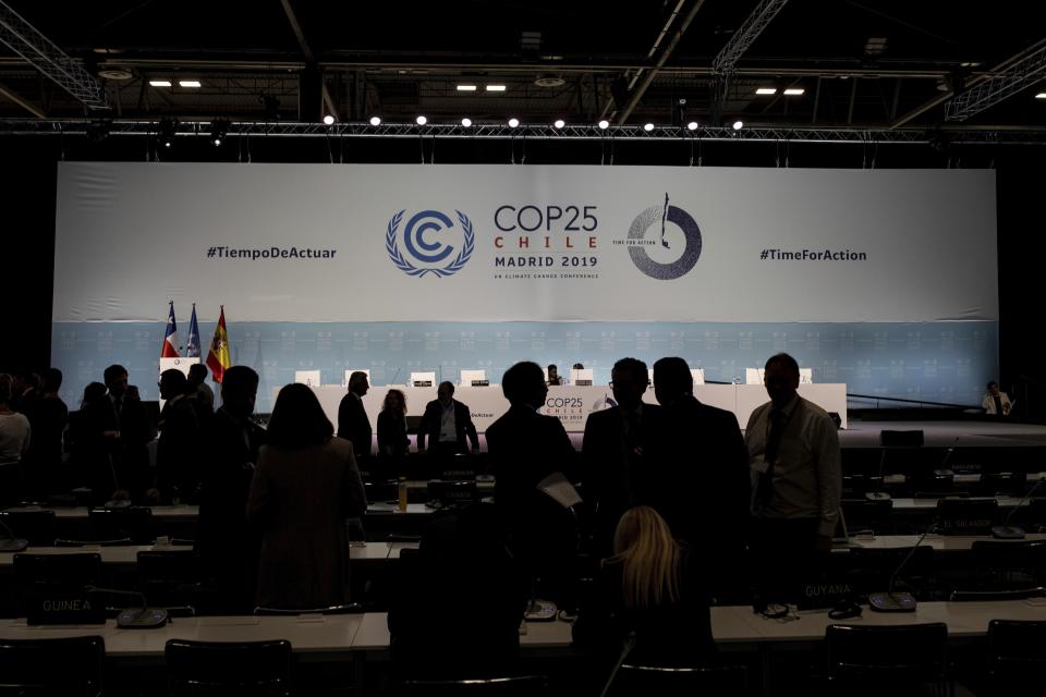 COP25 party members talk ahead of the closing plenary in Madrid, Sunday Dec. 15, 2019. Negotiators from almost 200 nations planned to gather for a final time at the U.N. climate meeting in Madrid early Sunday to pass declarations calling for greater ambition in cutting planet-heating greenhouse gases and in helping poor countries suffering the effects of climate change. But one of the key issues at the talks, an agreement on international carbon markets, has eluded officials even after the Chilean chair extended Friday's talks deadline to allow more time for negotiations. (AP Photo/Bernat Armangue)