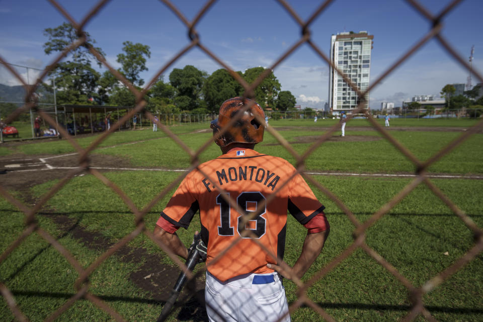 A Nicaraguan baseball player for the local Mets team waits to bat in a preparation game against La Carpio ahead of baseball season at Sabana Park in San Jose, Costa Rica, Sunday, Aug. 28, 2022. The number of players for the local league in Costa Rica has increased since Nicaraguans began seeking asylum at the highest levels since their country['s political crisis exploded in April 2018. (AP Photo/Moises Castillo)