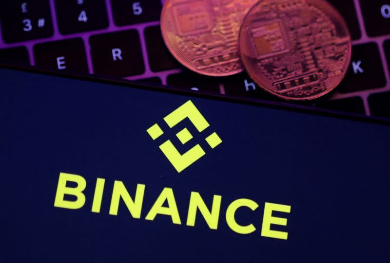 FILE PHOTO: Illustration shows Binance logo and representation of cryptocurrencies