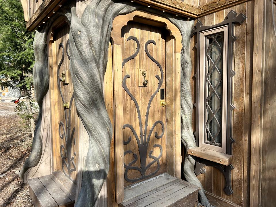 intricate wooden doors on rumpelstilskin's tower