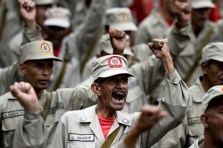 Members of the Bolivarian Militia take part in a parade in the framework of the seventh anniversary of the force, in front of the Miraflores presidential palace in Caracas on April 17, 2017