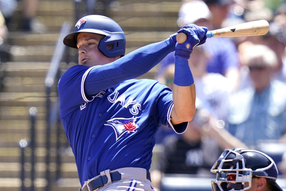 Toronto Blue Jays' Matt Chapman follows through on a single during the third inning of a spring training baseball game against the New York Yankees, Saturday, March 26, 2022, in Tampa, Fla. (AP Photo/Lynne Sladky)