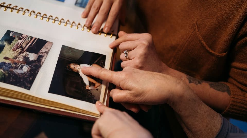 Maralee Hill and her daughter Victoria Hill look through old family albums in Wethersfield, Connecticut. - Laura Oliverio/CNN