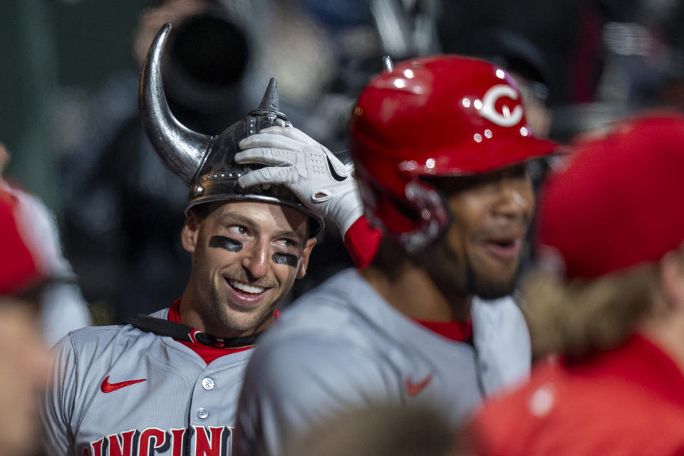 Cincinnati Reds' Spencer Steer, left, celebrates hitting a grand slam with his teammates during the tenth inning of a baseball game against the Philadelphia Phillies, Monday, April 1, 2024, in Philadelphia. (AP Photo/Chris Szagola)