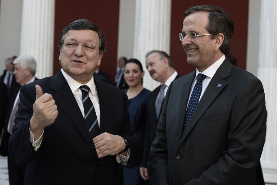 Greek Prime Minister Antonis Samaras, right, listens to European Commission President Jose Manuel Barroso during the take over ceremony of the six-month rotation of the Greek EU Presidency at Zappeion Hall in Athens, on Wednesday, Jan. 8, 2014. (AP Photo/Aris Messinis, Pool)