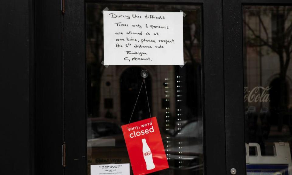 A sign is placed in the window of a restaurant with distancing guidelines as Ohio implements phase one of reopening in Columbus, Ohio, on 1 May.