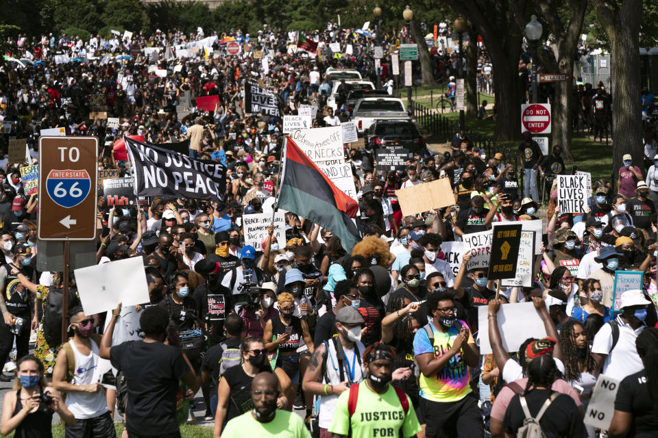 People start marching at Lincoln Memorial during the March on Washington, Friday Aug. 28, 2020, on the 57th anniversary of the Rev. Martin Luther King Jr.'s "I Have A Dream" speech. (AP Photo/Jose Luis Magana)