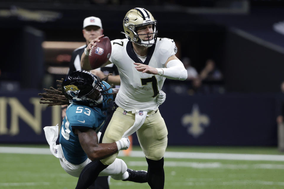 New Orleans Saints quarterback Taysom Hill passes under pressure from Jacksonville Jaguars linebacker Dakota Allen (53) in the first half of an NFL preseason football game in New Orleans, Monday, Aug. 23, 2021. (AP Photo/Derick Hingle)