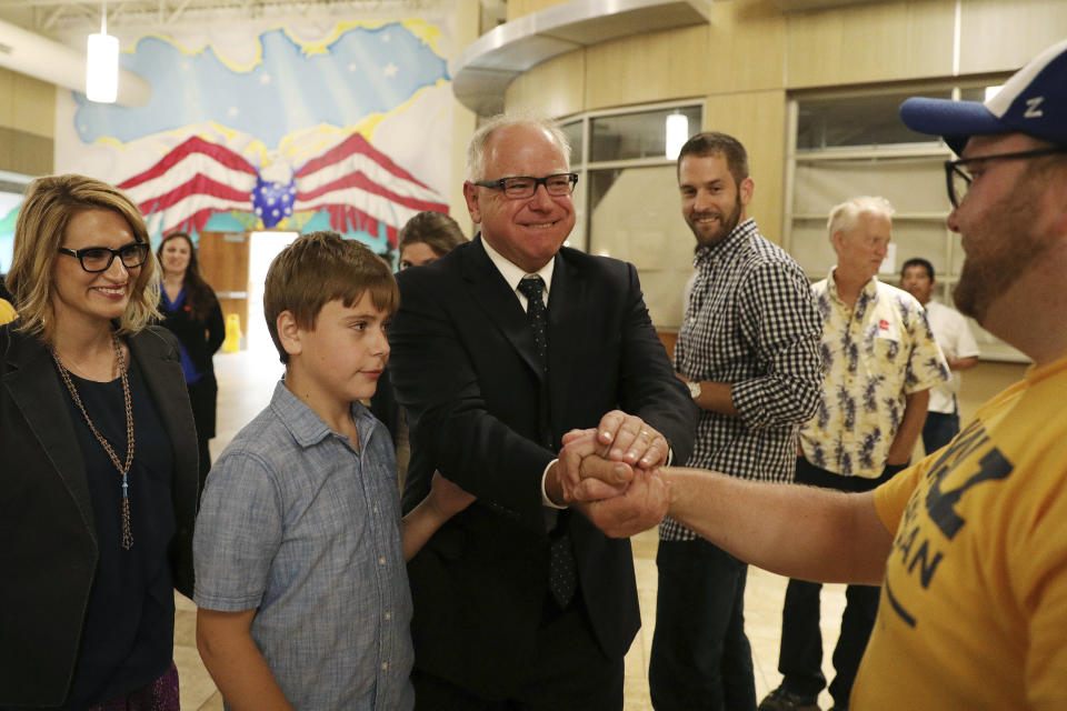 DFL gubernatorial candidate Tim Walz, center, his son Gus and his running mate, Peggy Flanagan, left, greet supporters during their primary election night party at the Carpenters Union Hall in St. Paul, Minn., Tuesday, Aug. 14, 2018. (Anthony Souffle/Star Tribune via AP)