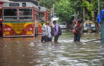 Mumbai: People wade through a waterlogged street at Lalbaug-Parel area, after heavy monsoon rain, in Mumbai, Wednesday, Sept. 23, 2020. (PTI Photo)(PTI23-09-2020_000095B)