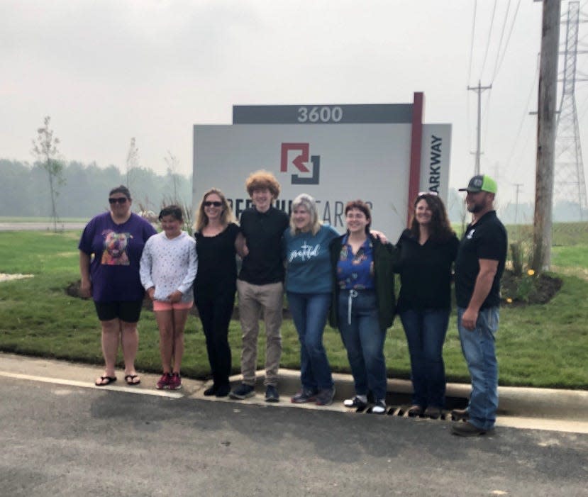 Members of the Emswiler stand in front of the sign for Red Chip Farms, a 350-acre development within the Pataskala Corporate Park. The land was previously owned by Howard "Red" Emswiler.